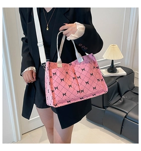 Detail of pink corduroy tote bag with bow print and adjustable white shoulder strap