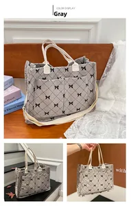 Detail view of grey corduroy tote bag with black bow print and dual shoulder straps