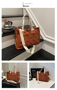 Close-up of brown corduroy tote bag with diamond pattern and bow details