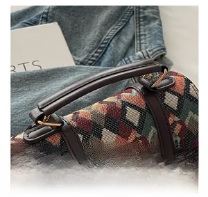 Close-up of retro patchwork fabric texture with leather straps and gold metal buckles