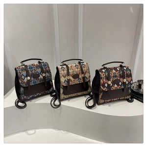 Three retro geometric jacquard backpacks on display with premium leather trim details