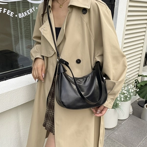 Minimalist black crescent shoulder bag with wide strap for versatile daily use