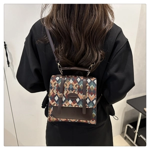 Detail of vintage geometric woven backpack with quilted texture and brown leather trim