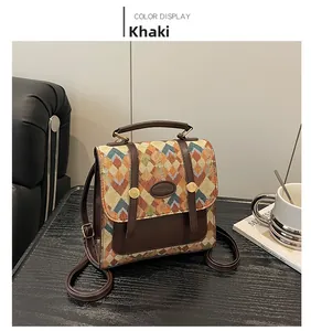 Detail of khaki patchwork backpack with vintage geometric patterns on a wooden desk