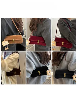 Detail view of baguette bags in multiple colors featuring metal lock and plush bear charm