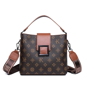 Vintage brown monogram bucket bag with retro K-pattern and wide shoulder strap