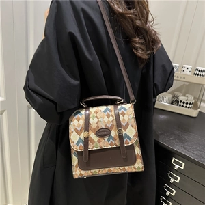 Retro jacquard crossbody bag with geometric patterns and leather trim on model