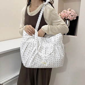 Minimalist white tote bag with black polka dots and soft pleated design for women