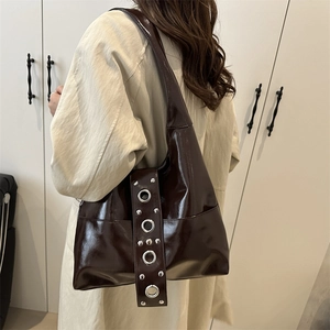 Vintage brown leather punk tote bag with silver metal eyelets and rivet decorations
