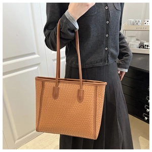 Detailed woven texture and large capacity of this brown shoulder tote bag for women