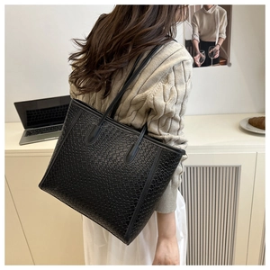 Detailed view of black woven texture on a large tote bag for professional commuting