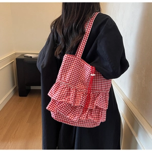 Detail of red and white gingham tote bag with double layer ruffle trim and drawstring