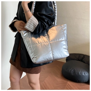 Detail of silver metallic quilted tote bag with large capacity and rhomboid texture