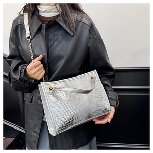 Détail du sac cabas argenté à motif crocodile avec bandoulière chaîne sur modèle