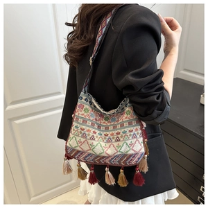 Detail showing the colorful Bohemian tassel fringe and ethnic geometric embroidery pattern