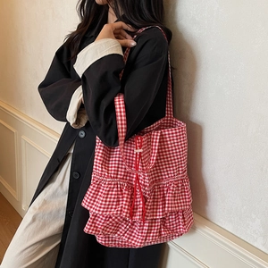 Fashionable red and white checkered tote bag with ruffle detail and drawstring