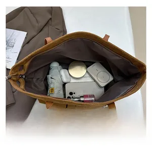 Spacious interior of brown canvas tote bag showing storage for daily essentials