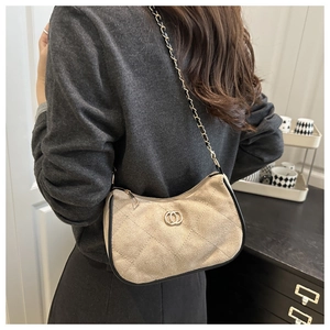 Detail of khaki faux suede crossbody bag with quilted pattern and metal chain strap