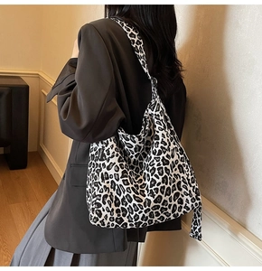 Detail of stylish leopard print canvas tote bag with large capacity for daily use