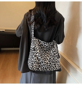 Close-up of black and white leopard print canvas tote bag with a fashion woven label