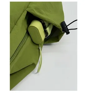 Macro shot of backpack side zipper pocket holding a mini umbrella for storage