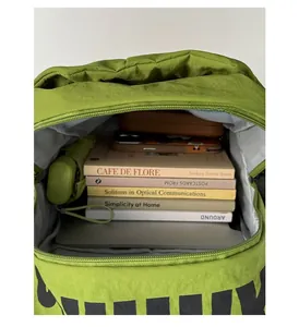 Internal view of green water-resistant backpack showing large capacity and storage compartments