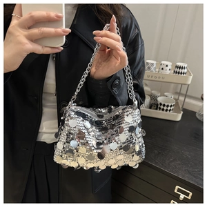 Detail of silver sequin handbag featuring a metallic chain strap and zipper closure