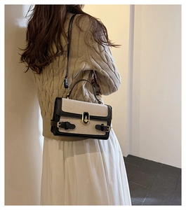 Detail of color-block retro crossbody bag with golden lock on a knit sweater outfit