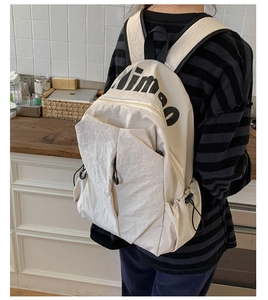 Detail shot of off-white waterproof nylon backpack with multi-pocket design and dimoo logo