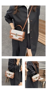 Close-up of contrast linen crossbody bag with brown leather trim and golden twist lock
