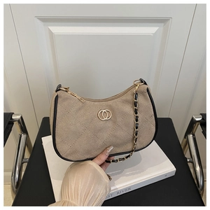 Detail of khaki quilted canvas underarm bag with gold metal buckle and leather chain strap