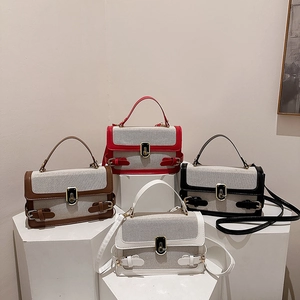 Modern color-block canvas and leather handbags in four colors on geometric display stands