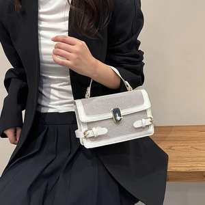 Modern white mesh and leather contrast handbag with gold buckle and shoulder strap