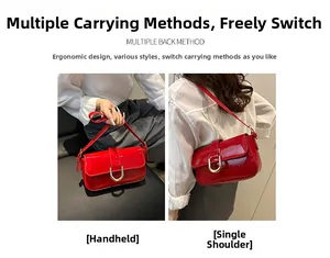 Detail of red patent leather handbag with gold horsebit buckle in hand and shoulder style