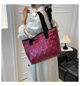 Detailed view of pink metallic puffer tote bag featuring embossed rabbit pattern