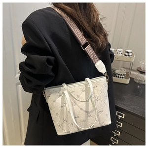 Detail of white leather tote with LNBOE bunny prints and patterned fabric shoulder strap