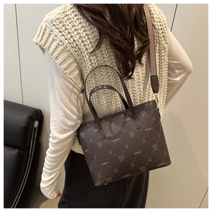 Back view of brown tote bag with logo pattern and colorful woven shoulder strap