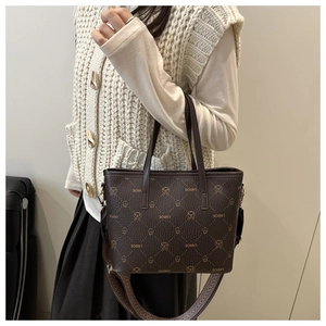 Detail view of coffee-colored tote bag with LNBOE patterns and stylish woven shoulder strap