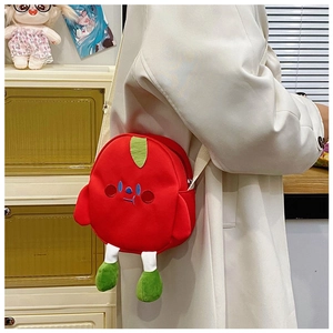 Detail of red cartoon plush crossbody bag with embroidery and green leaf decor