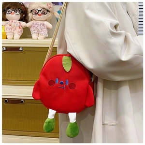 Detail of red fruit plush crossbody bag featuring cute cartoon embroidery and green leaf
