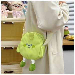 Close-up of a green cartoon canvas crossbody bag with 3D legs and cute embroidery details