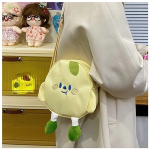 Detail of cute yellow cartoon plush crossbody bag featuring 3D wings and embroidery