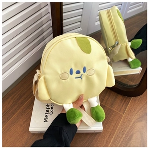 Detail of yellow canvas cartoon crossbody bag with embroidery and 3D feet features