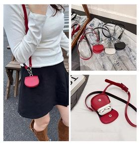 Detail view of mini leather earphone case with magnetic closure and adjustable strap