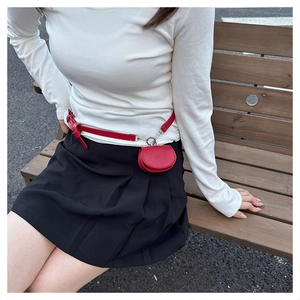 Red mini belt bag and small leather pouch styled on waist with silver metal clasp