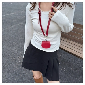 Close-up of a mini semi-circle red leather waist bag for lipsticks and earphones