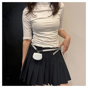 Mini semi-circle waist bag on silver belt styled with a white top and pleated skirt