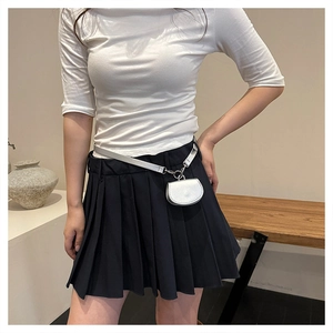 Mini semi-circle waist bag with silver decorative belt shown on a black pleated skirt