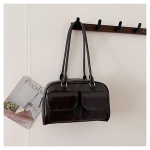 Detail of dark brown faux leather underarm bag with double front flap pockets
