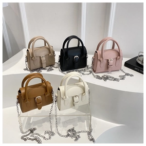 Minimalist crossbody mini bags in five colors with silver chain straps on white display
